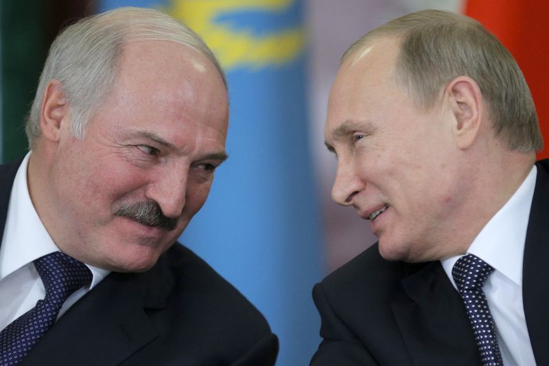 FILE - Russian President Vladimir Putin, right, and his Belarus counterpart, Alexander Lukashenko, talk at an economic summit in the Kremlin, in Moscow, Russia, on Dec. 23, 2014. (AP Photo/ Maxim Shipenkov, Pool, File)