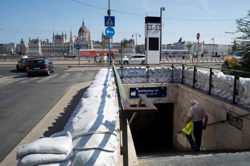 A workers walks down to a metro station protected by sandbags as the Danube river floods it's banks, central Budapest, Hungary, Thursday, Sept. 19, 2024. (AP Photo/Denes Erdos)