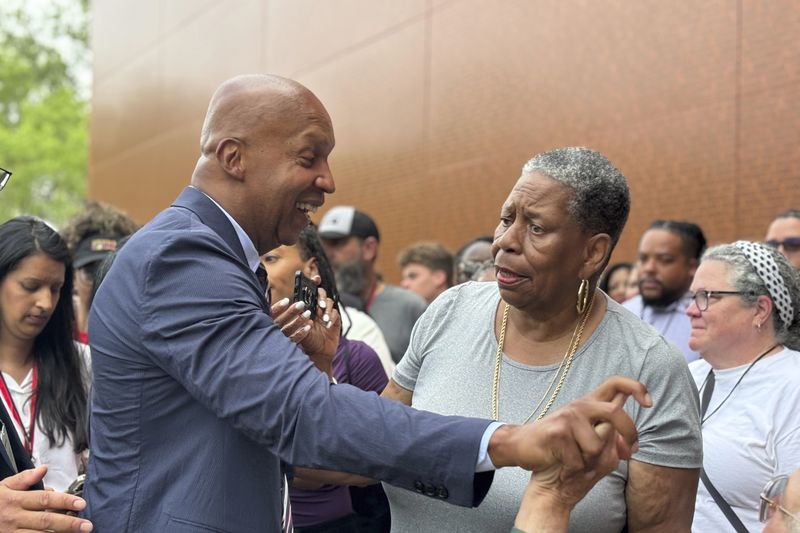 Bryan Stevenson, the founder of the Equal Justice Initiative, speaks with JoAnne Bland and other well-wishers after the dedication of the National Monument to Freedom on June 19, 2024, in Montgomery, Ala. (AP Photo/Kim Chandler)