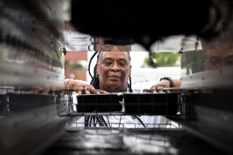 Meals on Wheels employee Tracey Hill loads hot meals into a special warming section of her delivery truck, Friday, July 12, 2024, in Houston. Hill has been delivering meals for the organization for nine years. (AP Photo/Annie Mulligan)