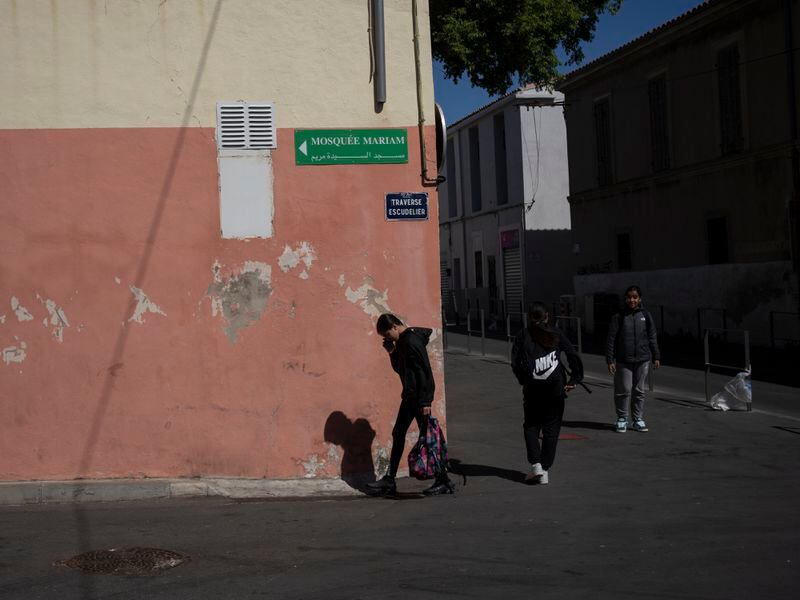 Students walk outside the mosque at Ibn Khaldoun, a private Muslim school, in Marseille, southern France, Tuesday, April 16, 2024. (AP Photo/Daniel Cole)