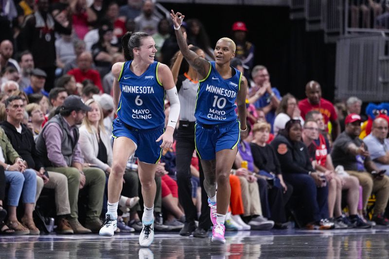 Minnesota Lynx players Courtney Williams (10) and forward Bridget Carleton (6) celebrate after Williams made a three-point basket against the Indiana Fever during the second half of a WNBA basketball game in Indianapolis, Friday, Sept. 6, 2024. (AP Photo/Michael Conroy)