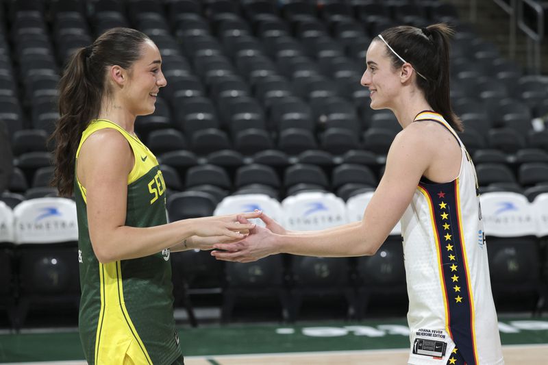 Seattle Storm guard Nika Muhl, left, and Indiana Fever guard Caitlin Clark greet each other following a WNBA basketball game, Wednesday, May 22, 2024, in Seattle. The Storm won 85-83. (AP Photo/Jason Redmond)