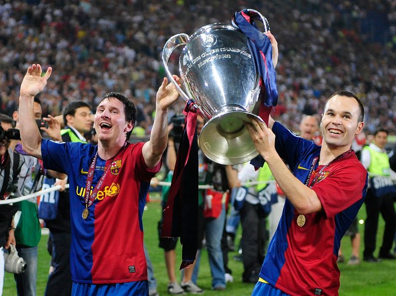 FILE - Barcelona's Andres Iniesta, right, and Lionel Messi hold the trophy at the end of the Champions League final soccer match between Manchester United and Barcelona in Rome, on May 27, 2009. Andres Iniesta who scored Spain's World Cup-winning goal in 2010 and was one of the key players who made Barcelona's tiki-taka thrive for so long, announced his retirement from soccer on Tuesday. (AP Photo/Manu Fernandez, File)