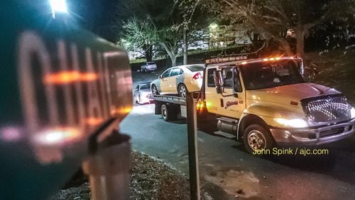 A car is towed from an apartment complex on Quail Run off Snapfinger Woods Road Monday morning after a deadly shooting in the parking lot.