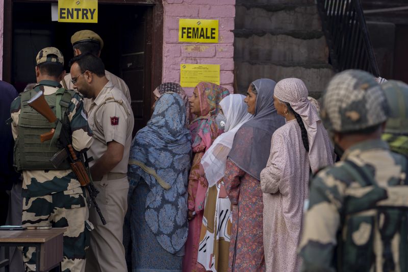 Kashmiri women queue up at a polling booth to cast their vote during the second phase of the assembly election in the outskirts of Srinagar, Indian controlled Kashmir, Wednesday, Sept. 25, 2024. (AP Photo/Dar Yasin)