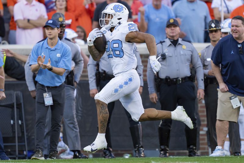 FILE - North Carolina running back Omarion Hampton (28) runs with the ball against Clemson during an NCAA college football game Saturday, Nov. 18, 2023, in Clemson, S.C. (AP Photo/Jacob Kupferman, File)