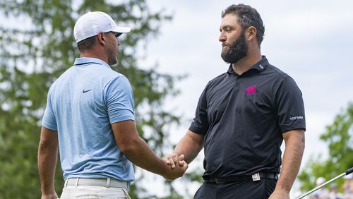 Captain Brooks Koepka, left, of Smash GC, shakes hands with captain Jon Rahm, of Legion XIII, on the 18th green during the final round of LIV Golf Greenbrier at The Old White at The Greenbrier, Sunday, Aug. 18, 2024, in White Sulphur Springs, W.Va. (Mike Stobe/LIV Golf via AP)