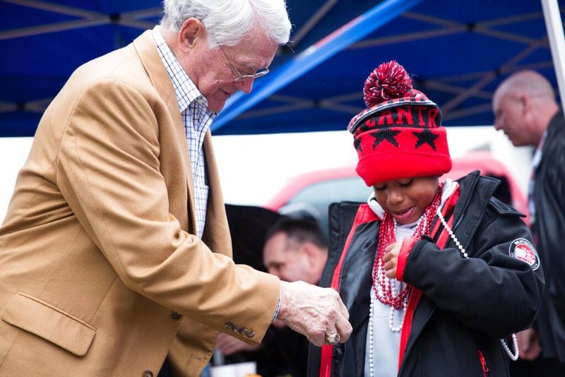 Former Atlanta Falcons head coach Dan Reeves greets a young fan at the Built Ford Tough Toughest Tailgate on Sunday, Jan. 1, 2017, in Atlanta. (Branden Camp/AP Images for Ford)