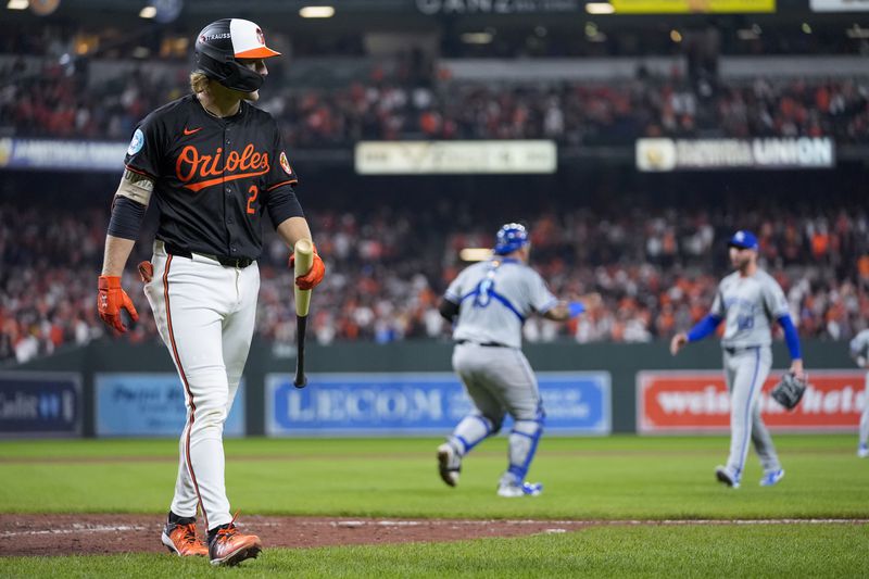 Baltimore Orioles' Gunnar Henderson, left, walks to the dugout after striking out for the final out as Kansas City Royals pitcher Lucas Erceg, right, and catcher Salvador Perez react following Game 2 of an AL Wild Card Series baseball game, Wednesday, Oct. 2, 2024 in Baltimore. The Royals won 2-1. (AP Photo/Stephanie Scarbrough)