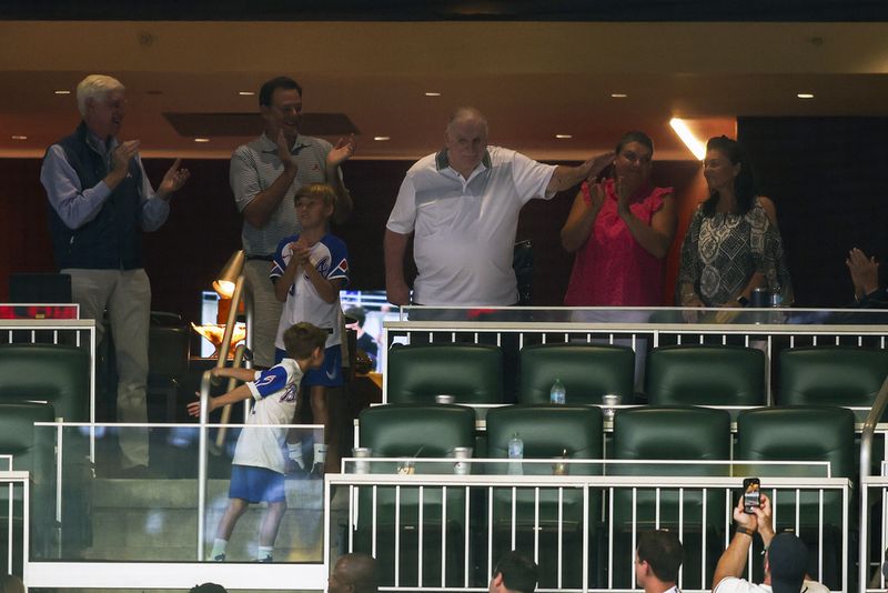 Former Atlanta Braves manager Bobby Cox, center top, waves to the crowd during a baseball game against the Philadelphia Phillies, Saturday, July 6, 2024, in Atlanta. (AP Photo/Brett Davis)