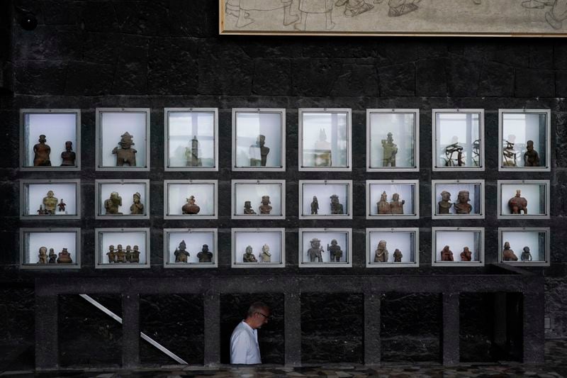 Pre-hispanic ceramics are displayed in glass front niches in the Anahuacalli Museum in Mexico City, Tuesday, Aug. 20, 2024. Built by Mexican artist Diego Rivera to preserve and display his lifelong collection of pre-Hispanic art, the museum is celebrating its 60th anniversary. (AP Photo/Eduardo Verdugo)