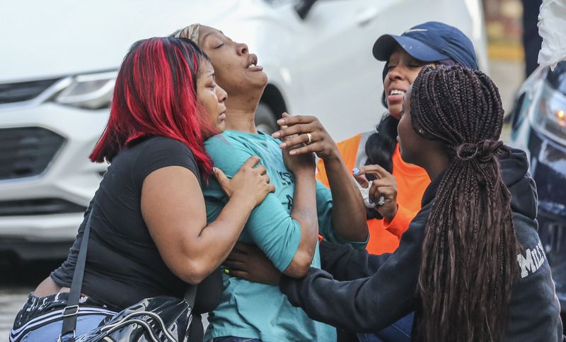 Sanmarian McClain (center-left) is comforted in her grief after losing her daughter to gunfire Thursday, Oct. 3, 2019. An 18-year old woman is dead after a stray bullet flew into her southwest Atlanta home and hit her as she slept. Gunfire erupted Thursday, in the street outside the home in the 2900 block of River Ridge Drive, according to Atlanta homicide commander Lt. Andrea Webster. Officers were sent to the residence about 6 a.m. after a woman reported her daughter had been shot and killed. When officers went inside the home, they found the victim with a gunshot wound to the chest, police said. Emergency medical officials confirmed she was dead.  Investigators learned there was an exchange between at least two shooters that may have lasted several minutes, Webster said. During that time, three stray bullets came into the house, one of which hit and killed the sleeping teen, she said.  âWe canât think of any reason she may have been the subject or the target,â Webster said.  The 18-year-old, identified by relatives as Jessica Daniels, had just graduated from South Atlanta High School in May, her mother told police.