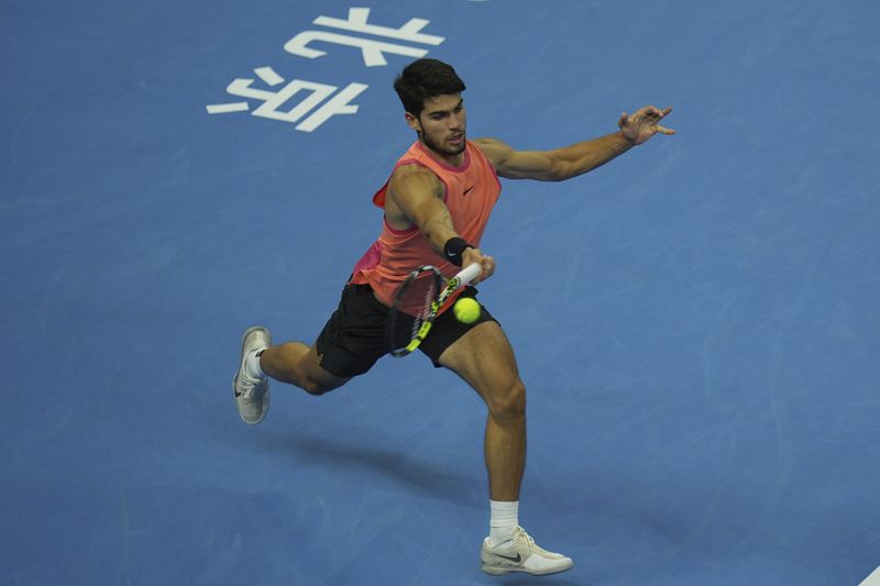 Carlos Alcaraz of Spain returns a shot from Daniil Medvedev of Russia during their men's singles semi-final match for the China Open tennis tournament held at the National Tennis Center in Beijing, Tuesday, Oct. 1, 2024. (AP Photo/Ng Han Guan)