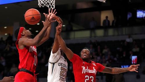 Nebraska guards Dachon Burke Jr. (11) and Jervay Green (23) battle Georgia Tech guard Shembari Phillips (2) for a rebound in the first half of an NCAA college basketball game Wednesday, Dec. 4, 2019, in Atlanta. (AP Photo/John Bazemore)