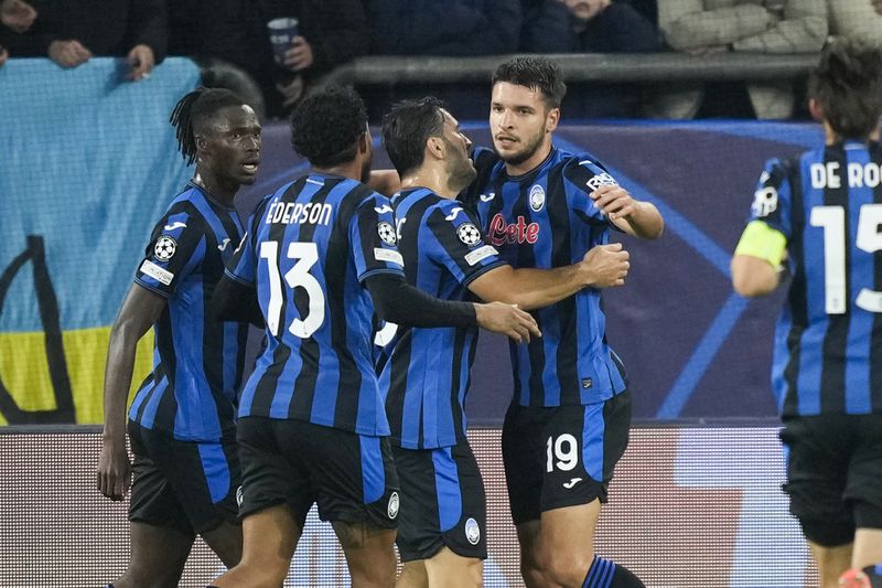 Atalanta's Berat Djimsiti celebrates with his teammates after scoring the opening goal during the Champions League opening phase soccer match between Shakhtar Donetsk and Atalanta at the Arena AufSchalke in Gelsenkirchen, Germany, Wednesday Oct. 2, 2024. (AP Photo/Martin Meissner)