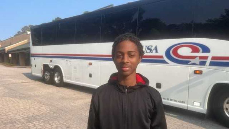 Willie Atkinson, 14, who will be a freshman at Chamblee High School this fall, stands in front of a bus he rode on June 16, 2023, with about two dozen DeKalb County students to Montgomery, Alabama, to visit the Legacy Museum. Organizers of the bus trip wanted the students to learn more about the legacy of slavery to better understand their history. (Eric Stirgus/eric.stirgus@ajc.com)