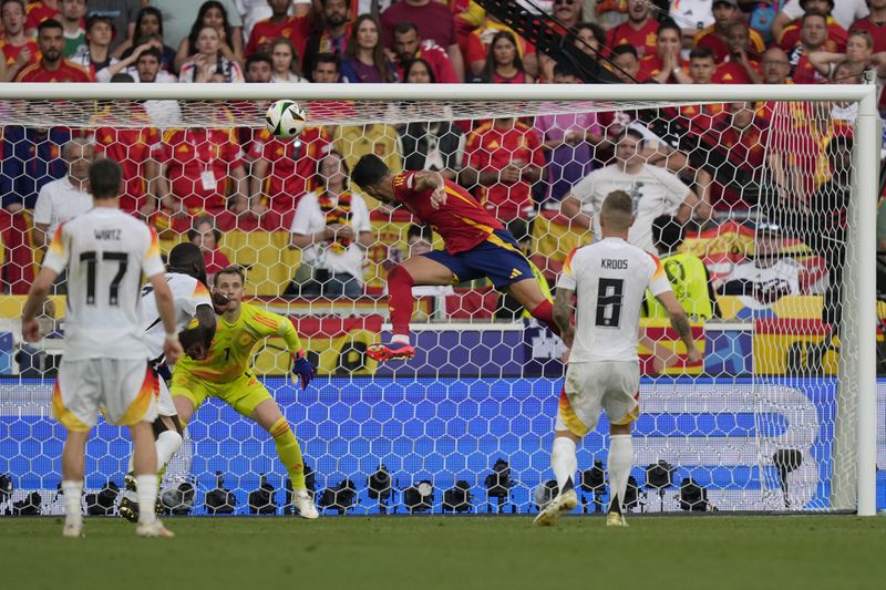 Spain's Mikel Merino, centre, scores his side's second goal during a quarter final match between Germany and Spain at the Euro 2024 soccer tournament in Stuttgart, Germany, Friday, July 5, 2024. (AP Photo/Ariel Schalit)
