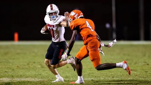 North Gwinnett wide receiver Cade Funderburk (11) runs the ball and attempts to stiff arm Parkview defensive back Mike Matthews (4) during a GHSA 7A high school football game between the North Gwinnett Bulldogs and the Parkview Panthers at Parkview High School in Lilburn, Ga., on Friday, Sept. 3, 2021. (Casey Sykes for The Atlanta Journal-Constitution)