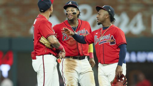 Atlanta Braves shortstop Orlando Arcia, left, right fielder Ronald Acuna Jr., center, and second baseman Ozzie Albies talk during a delay in the game against the Miami Marlins at Truist Park, Friday, June 30, 2023, in Atlanta. Jason Getz / Jason.Getz@ajc.com)