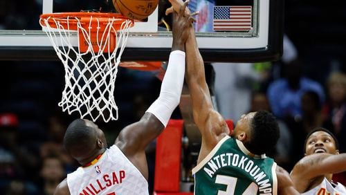 Bucks forward Giannis Antetokounmpo (34) has his shot blocked by Hawks forward Paul Millsap (4) in the first half of an NBA basketball game Wednesday, Nov. 16, 2016, in Atlanta. (AP Photo/John Bazemore)