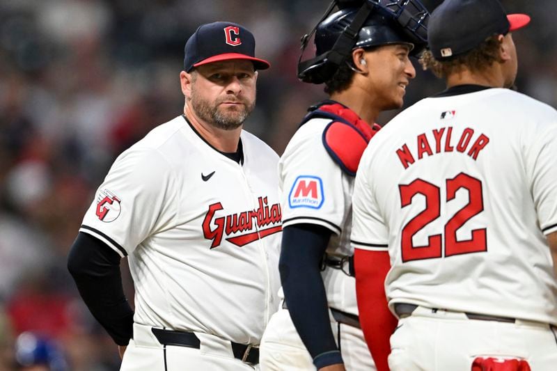 Cleveland Guardians manager Stephen Vogt, left, makes a pitching change during the sixth inning of the second game of a baseball doubleheader against the Kansas City Royals, Monday, August 26, 2024, in Cleveland. (AP Photo/Nick Cammett)