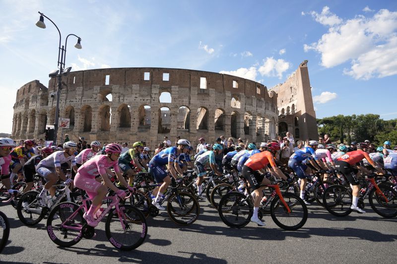 Cyclists, including the pink jersey overall leader Slovenia's Tadej Pogacar, ride past the ancient Colosseum during the final stage of the Giro d'Italia cycling race in Rome, Sunday, May 26, 2024. (AP Photo/Andrew Medichini)