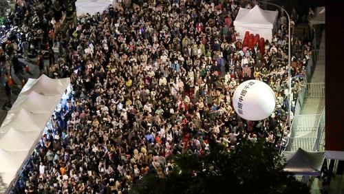 Supporters of the ruling Democratic Progressive Party (DPP) gather and push an ball reading ''Reject China's Interference In Politics'' outside of the legislative building in Taipei, Taiwan, Tuesday, May 28, 2024. (AP Photo/Chiang Ying-ying)