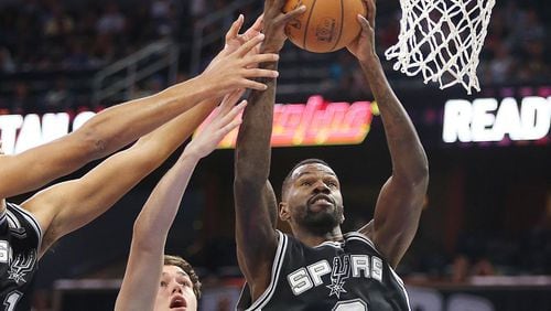 The San Antonio Spurs’ Dewayne Dedmon (3) takes the ball from the Orlando Magic’s Stephen Zimmerman (33) during a preseason game at the Amway Center in Orlando, Fla., on Wednesday, Oct. 12, 2016. The Spurs won, 95-89. (Stephen M. Dowell/Orlando Sentinel/TNS)