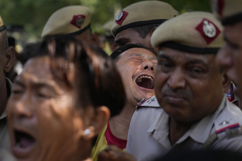 Exile Tibetans shout slogans against the human rights situation in Tibet during a protest to coincide China marking its 75th year of Communist Party rule, outside Chinese embassy, in New Delhi, India, Tuesday, Oct. 1, 2024. (AP Photo/Manish Swarup)