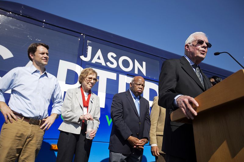 Former President Jimmy Carter, right, introduces his grandson, Georgia Democratic gubernatorial candidate Jason Carter, rear left, at a campaign stop with former first lady Rosalynn Carter and Rep. John Lewis, D-Ga., center left and right, Monday, Oct. 27, 2014, in Columbus, Ga. (AP Photo/David Goldman)