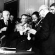 Tuesday marked 60 years since U.S. President Lyndon B. Johnson signed into law the Civil Rights Act of 1964. At the signing ceremony, Johnson reaches to shake hands with the Martin Luther King Jr. after presenting the civil rights leader with one of the 72 pens used to sign the measure. (AP Photo)
