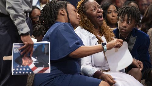 Meka Fortson (center), mother of Roger Fortson, grieves during her son’s funeral at Missionary Baptist Church in Stonecrest on May 17. Her 16-year-old son was shot to death Tuesday night.