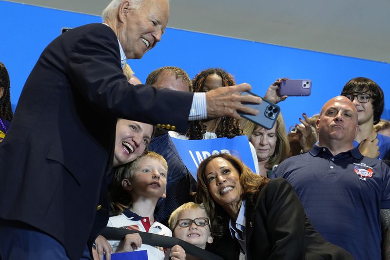 President Joe Biden take a photo as Democratic presidential nominee Vice President Kamala Harris poses as they campaign at the IBEW Local Union #5 union hall in Pittsburgh on Labor Day, Monday, Sept. 2, 2024. (AP Photo/Susan Walsh)