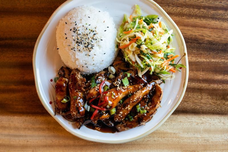 Teriyaki Chicken, thin sliced chicken cooked in homemade teriyaki sauce and a side of Asian sesame slaw. Photo credit- Mia Yakel.