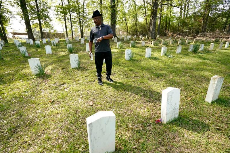 Charles Latham stands among the grave markers in the Confederate cemetery in Grenada, Miss., April 12, 2023. (AP Photo/Rogelio V. Solis)