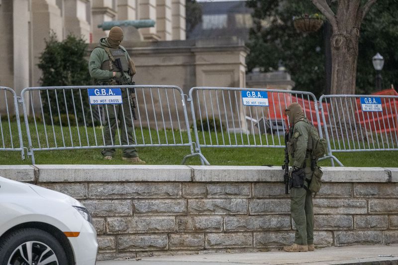 01/11/2021 — Atlanta, Georgia — Georgia State Trooper stand guard outside of the Georgia State Capitol building on the first day of the 2021 session in downtown Atlanta, Monday, January 11, 2021. (Alyssa Pointer / Alyssa.Pointer@ajc.com)