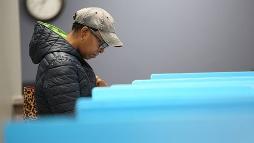 Vallerie Roy of Dekalb County cast her ballot during the first day of early voting at Voter Registration and Elections Office in Atlanta on Monday, March 2, 2020.