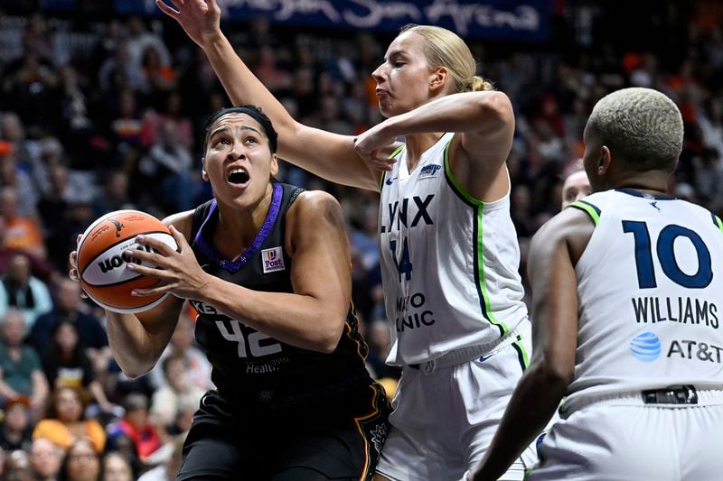 Connecticut Sun forward Brionna Jones (42) looks to shoot as Minnesota Lynx forward Dorka Juhasz (14) defends during the second half of a WNBA basketball semifinal game, Friday, Oct. 4, 2024, in Uncasville, Conn. (AP Photo/Jessica Hill)