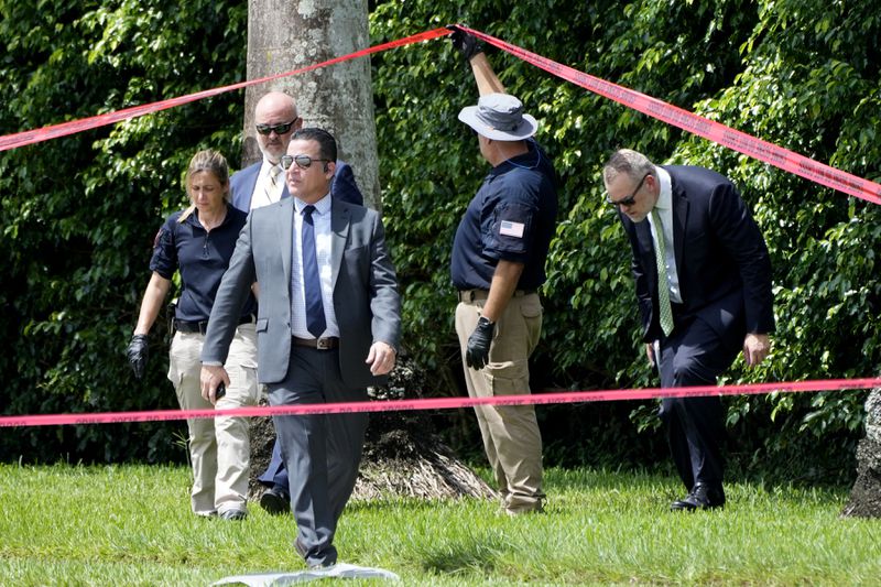 Law enforcement officials work outside of the Trump International Golf Club after the apparent assassination attempt of Republican presidential nominee and former President Donald Trump Monday, Sept. 16, 2024, in West Palm Beach, Fla. (AP Photo/Lynne Sladky)