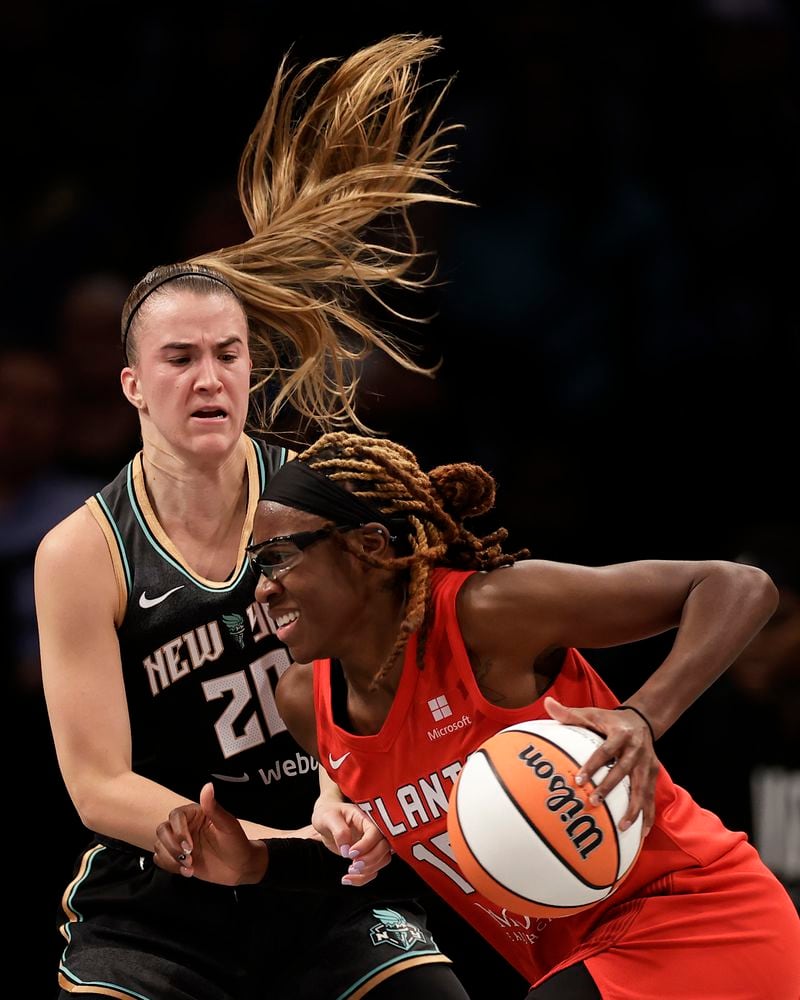 Atlanta Dream guard Allisha Gray drives past New York Liberty guard Sabrina Ionescu (20) during the first half of first-round WNBA basketball playoff game, Tuesday, Sept. 24, 2024, in New York. (AP Photo/Adam Hunger)