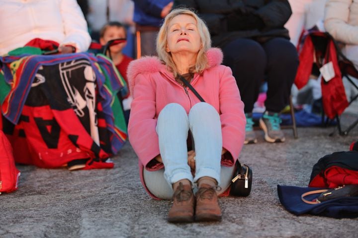 Donna Tribble from Alpharetta gets the first ray of light as the sun rises during the 76th annual Easter Sunrise Service on the top of Stone Mountain on Sunday, April 17, 2022. Miguel Martinez/miguel.martinezjimenez@ajc.com