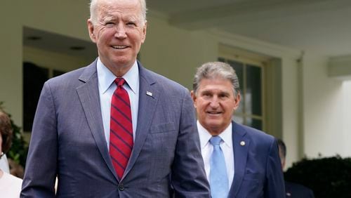 FILE - President Joe Biden, with Sen. Joe Manchin, D-W.Va., right, speaks outside the White House in Washington, June 24, 2021. Manchin, a Democrat turned independent, is urging Biden to drop his reelection bid and focus on the remaining months of his presidency. Manchin tells CNN Sunday, July 21, 2024, that he "came to the decision with a heavy heart that I think it's time to pass the torch to a new generation." (AP Photo/Jacquelyn Martin, File)