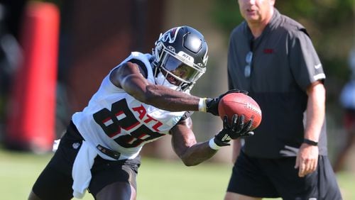 Falcons receiver Frank Darby makes a two-handed catch with wide receivers coach Dave Brock looking on during training camp last season in Flowery Branch. (Curtis Compton / Curtis.Compton@ajc.com)