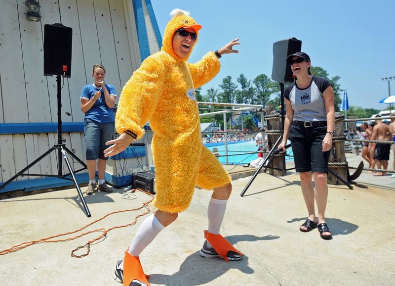 Kevin Avery (center), of 104.7 FM The Fish, dances to entertain as Taylor Scott (right) and Ashley Cunningham look on before the rubber duck derby begins in 2009. Nearly 10,000 yellow rubber ducks dump into the Little Hooch at Six Flags White Water to race around for prizes, with all proceeds benefiting the 22,769 athletes of Special Olympics Georgia.   Hyosub Shin / hshin@ajc.com