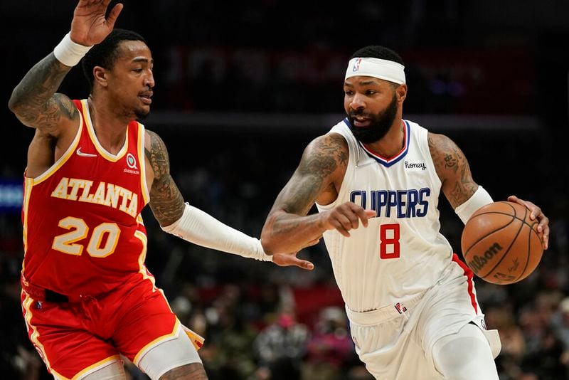 Los Angeles Clippers' Marcus Morris Sr., right, drives past Atlanta Hawks' John Collins during second half of an NBA basketball game Sunday, Jan. 9, 2022, in Los Angeles. (AP Photo/Jae C. Hong)