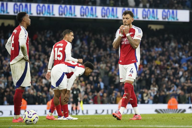 Arsenal players react after Manchester City's John Stones scored an equaliser in the English Premier League soccer match between Manchester City and Arsenal at the Etihad stadium in Manchester, England, Sunday, Sept. 22, 2024. (AP Photo/Dave Thompson)