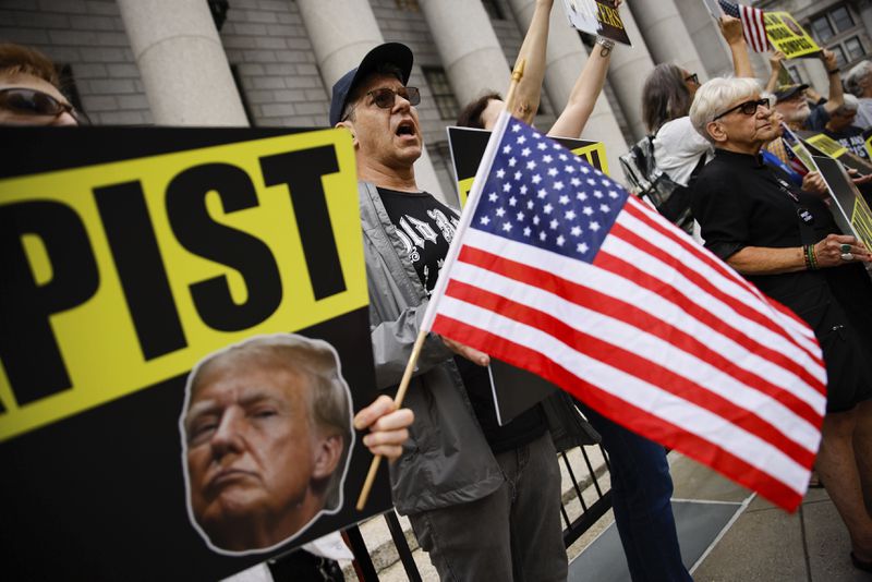 People protest against former President Donald Trump before his arrival to the New York Federal Court, Friday, Sept. 6, 2024, in New York. (AP Photo/Eduardo Munoz Alvarez)