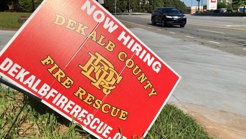 A "now hiring" sign sits outside a DeKalb County Fire Rescue station in Dunwoody on Thursday, April 21, 2022. J. SCOTT TRUBEY