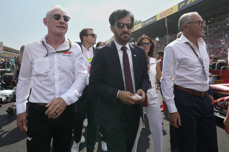 FIA president Mohammed Ben Sulayem, centre, walks through the starting grid before the Formula One Italian Grand Prix race at the Monza racetrack, in Monza, Italy, Sunday, Sept. 1, 2024. (AP Photo/Luca Bruno)